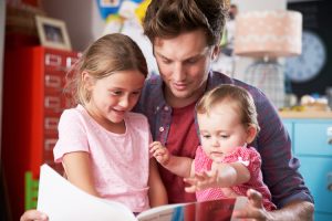 Father reading to his children