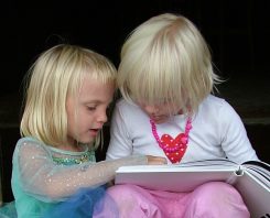 Young girls reading a book